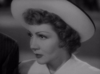 Movie still from “Arise, My Love” (1940), directed by Mitchell Leisen – An old black and white photo of a woman wearing a hat; Close Up shot, High angle