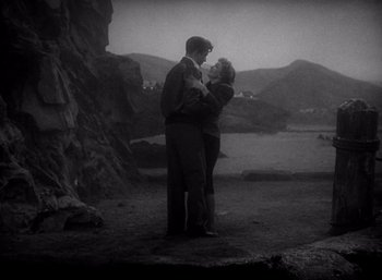 Movie still from “Arise, My Love” (1940), directed by Mitchell Leisen – A man and a woman standing next to each other on a hill; Wide shot, High angle