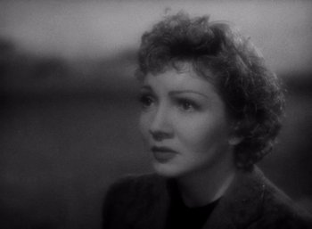 Movie still from “Arise, My Love” (1940), directed by Mitchell Leisen – An old photo of a woman with curly hair looking to her left; Close Up shot, High angle