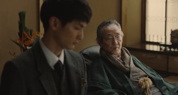 An older man sitting next to a younger man