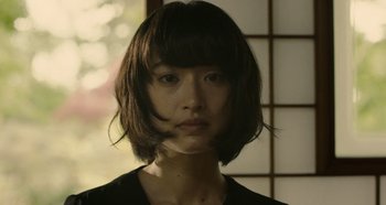 A woman with a short hair cut with bangs