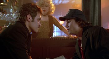 Movie still from “Arizona Dream” (1993), directed by Emir Kusturica – Two men and a woman in a restaurant; Medium shot, Over the shoulder angle