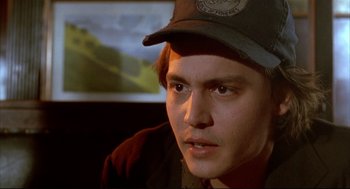 Movie still from “Arizona Dream” (1993), directed by Emir Kusturica – A person wearing a hat; Close Up shot, High angle