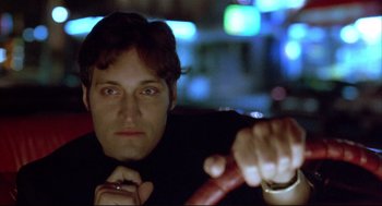 Movie still from “Arizona Dream” (1993), directed by Emir Kusturica – A man sitting in the driver's seat of a car at night; Close Up shot, Low angle