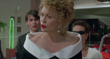 Movie still from “Arizona Dream” (1993), directed by Emir Kusturica – A person wearing a dress; Close Up shot, Over the shoulder angle