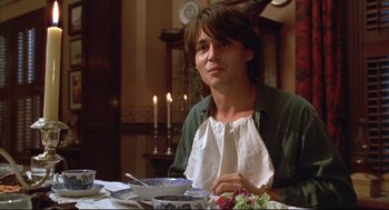 Movie still from “Arizona Dream” (1993), directed by Emir Kusturica – A man sitting at a table with a bowl of salad; Medium shot, High angle