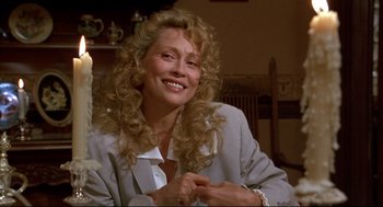 Movie still from “Arizona Dream” (1993), directed by Emir Kusturica – A woman with long blonde curly hair smiling; Close Up shot, Over the shoulder angle
