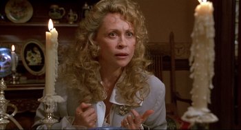 Movie still from “Arizona Dream” (1993), directed by Emir Kusturica – A woman with long blonde hair is looking at the camera; Close Up shot, Over the shoulder angle