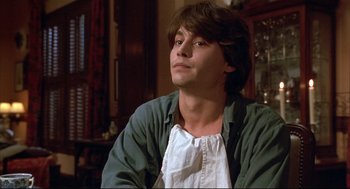 Movie still from “Arizona Dream” (1993), directed by Emir Kusturica – A man sitting in front of a mirror in a room; Close Up shot, Low angle