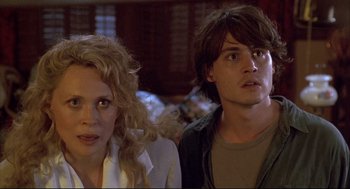 Movie still from “Arizona Dream” (1993), directed by Emir Kusturica – A man and a woman standing next to each other; Close Up shot, Over the shoulder angle