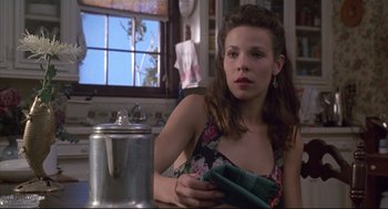 Movie still from “Arizona Dream” (1993), directed by Emir Kusturica – A woman sitting at a table in a kitchen; Close Up shot, Low angle