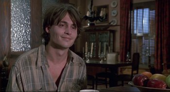 Movie still from “Arizona Dream” (1993), directed by Emir Kusturica – A man sitting at a table with a cup of coffee in front of him; Close Up shot, Over the shoulder angle