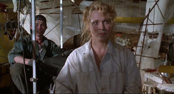Movie still from “Arizona Dream” (1993), directed by Emir Kusturica – A woman in white shirt standing next to a man in black shirt; Close Up shot, Low angle