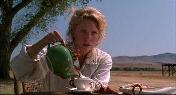 Movie still from “Arizona Dream” (1993), directed by Emir Kusturica – A woman pouring a cup of tea into a cup; Medium shot, Low angle