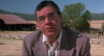 Movie still from “Arizona Dream” (1993), directed by Emir Kusturica – An older man wearing glasses and a suit; Close Up shot, Low angle