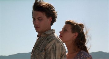 Movie still from “Arizona Dream” (1993), directed by Emir Kusturica – A man and a woman standing next to each other; Close Up shot, Low angle