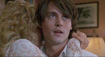 Movie still from “Arizona Dream” (1993), directed by Emir Kusturica – A person wearing a white shirt; Close Up shot, Over the shoulder angle