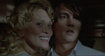 Movie still from “Arizona Dream” (1993), directed by Emir Kusturica – A man and a woman smiling for the camera; Close Up shot, High angle