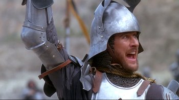 Movie still from “Army of Darkness” (1992), directed by Sam Raimi – A man wearing a helmet and holding a sword; Close Up shot, Low angle