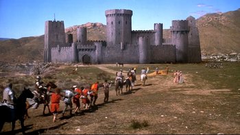 Movie still from “Army of Darkness” (1992), directed by Sam Raimi – A group of people on horseback in front of a castle; Extreme Wide shot, Low angle