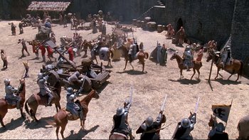 Movie still from “Army of Darkness” (1992), directed by Sam Raimi – A group of people on horses in a field; Extreme Wide shot, High angle