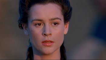 Movie still from “Army of Darkness” (1992), directed by Sam Raimi – A woman's face with a serious look on her face; Close Up shot, High angle