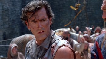 Movie still from “Army of Darkness” (1992), directed by Sam Raimi – A person wearing a shirt with blood all over it; Close Up shot, Over the shoulder angle