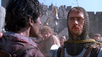 Movie still from “Army of Darkness” (1992), directed by Sam Raimi – Two men in medieval garb in front of a crowd; Close Up shot, Over the shoulder angle