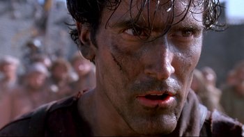 Movie still from “Army of Darkness” (1992), directed by Sam Raimi – A person with dirt on his face; Close Up shot, Low angle