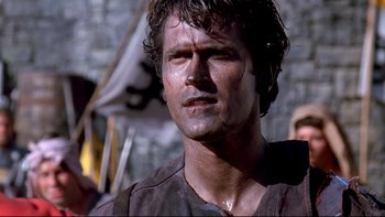 Movie still from “Army of Darkness” (1992), directed by Sam Raimi – A person wearing a shirt; Close Up shot, Low angle