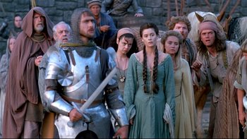 Movie still from “Army of Darkness” (1992), directed by Sam Raimi – A group of people standing next to each other; Medium shot, Over the shoulder angle