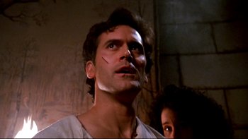 Movie still from “Army of Darkness” (1992), directed by Sam Raimi – A person with makeup on their face; Close Up shot, Low angle