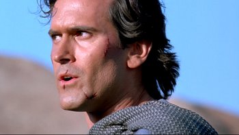 Movie still from “Army of Darkness” (1992), directed by Sam Raimi – A person with a wound on his face; Close Up shot, Low angle