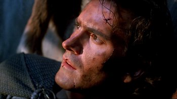 Movie still from “Army of Darkness” (1992), directed by Sam Raimi – A man's face in a dark room; Close Up shot, Low angle