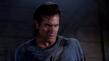 Movie still from “Army of Darkness” (1992), directed by Sam Raimi – A person wearing a blue shirt; Close Up shot, Over the shoulder angle