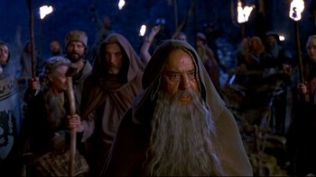 Movie still from “Army of Darkness” (1992), directed by Sam Raimi – A group of men in robes and headgear; Medium shot, Low angle