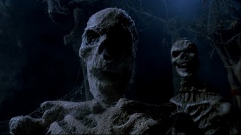 Movie still from “Army of Darkness” (1992), directed by Sam Raimi – The face of an undead creature; Close Up shot, Low angle