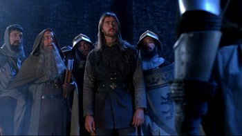 Movie still from “Army of Darkness” (1992), directed by Sam Raimi – A group of men standing next to each other; Medium shot, Low angle