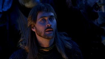 Movie still from “Army of Darkness” (1992), directed by Sam Raimi – A person with long hair and a beard; Close Up shot, Low angle