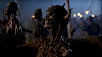 Movie still from “Army of Darkness” (1992), directed by Sam Raimi – A statue of a demon with horns; Close Up shot, Low angle