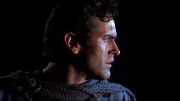 Movie still from “Army of Darkness” (1992), directed by Sam Raimi – A person with a face paint on; Close Up shot, Low angle