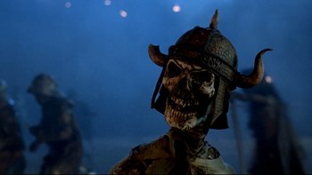 Movie still from “Army of Darkness” (1992), directed by Sam Raimi – A skeleton wearing a helmet and a suit; Close Up shot, Low angle