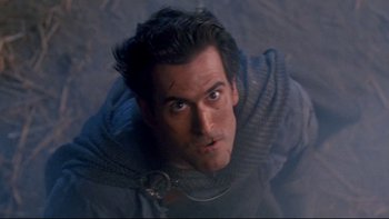 Movie still from “Army of Darkness” (1992), directed by Sam Raimi – A person wearing a suit of armor; Close Up shot, Low angle