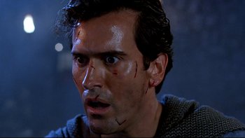 Movie still from “Army of Darkness” (1992), directed by Sam Raimi – A person with a scar on his face; Close Up shot, Low angle