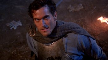 Movie still from “Army of Darkness” (1992), directed by Sam Raimi – A person wearing a chain mail armor; Close Up shot, High angle