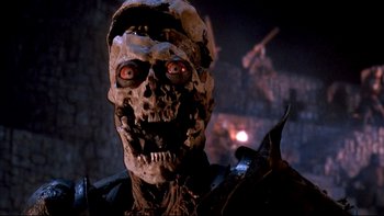 Movie still from “Army of Darkness” (1992), directed by Sam Raimi – The head of a skeleton with red glowing eyes; Close Up shot, Low angle