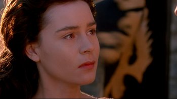 Movie still from “Army of Darkness” (1992), directed by Sam Raimi – A person looking to their left; Close Up shot, Over the shoulder angle