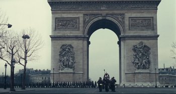 Movie still from “Army of Shadows” (1969), directed by Jean-Pierre Melville – A group of people riding horses in front of an arch; Extreme Wide shot, Low angle