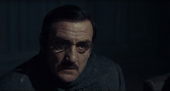 Movie still from “Army of Shadows” (1969), directed by Jean-Pierre Melville – A person wearing glasses; Close Up shot, Low angle