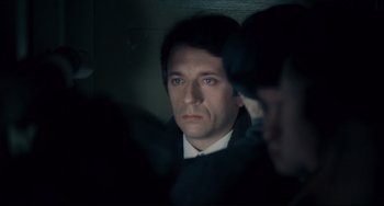 Movie still from “Army of Shadows” (1969), directed by Jean-Pierre Melville – A person wearing a suit and tie; Close Up shot, Over the shoulder angle